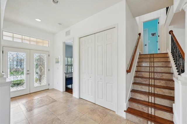 tiled entryway featuring french doors