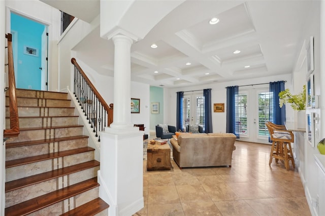 living room featuring coffered ceiling, beam ceiling, ornate columns, and french doors