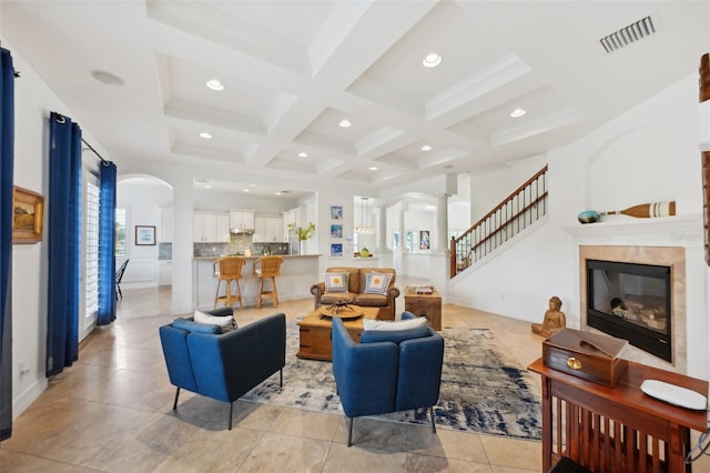 living room featuring beamed ceiling, light tile patterned floors, crown molding, and coffered ceiling