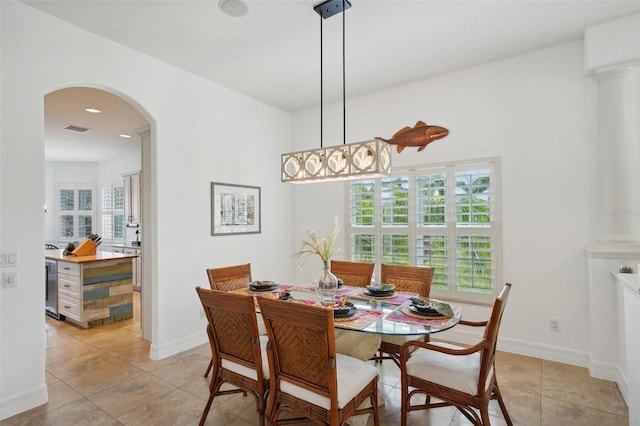 tiled dining area with wine cooler and a chandelier