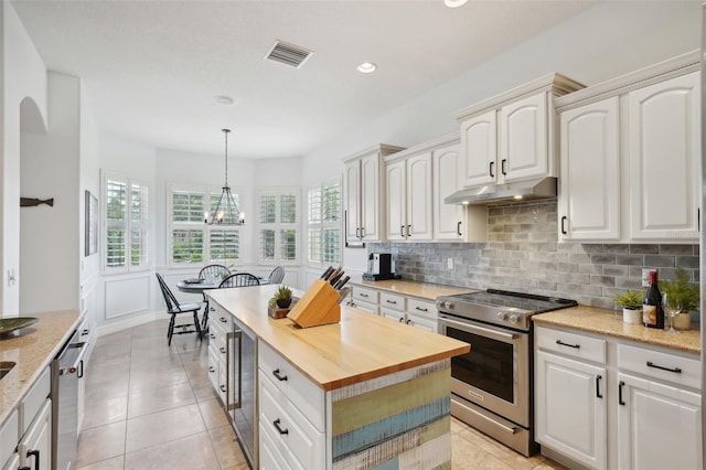 kitchen with stainless steel electric range oven and white cabinets