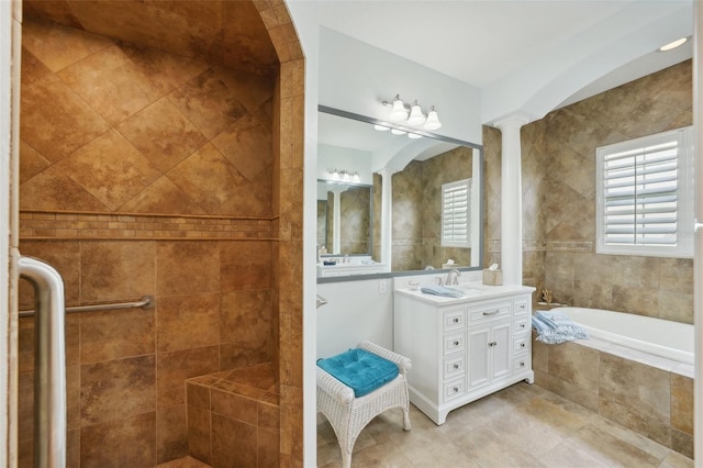 bathroom with vanity, ornate columns, and separate shower and tub