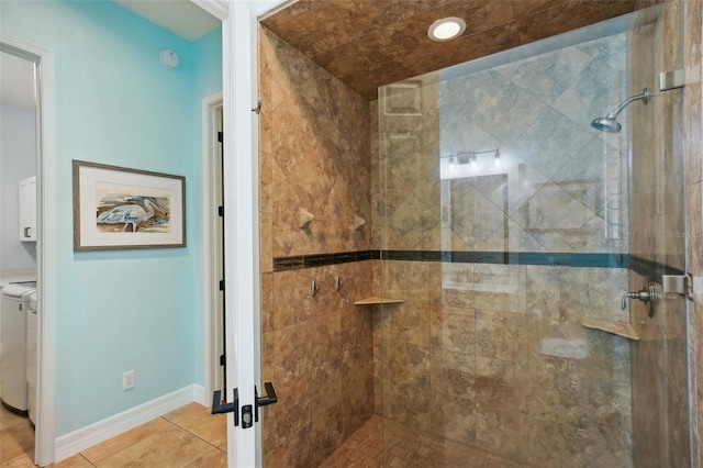 bathroom featuring tile patterned flooring and tiled shower