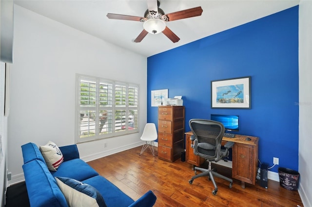 home office featuring dark hardwood / wood-style flooring and ceiling fan