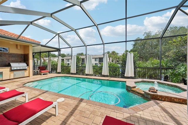 view of swimming pool with a patio, area for grilling, a lanai, and exterior kitchen