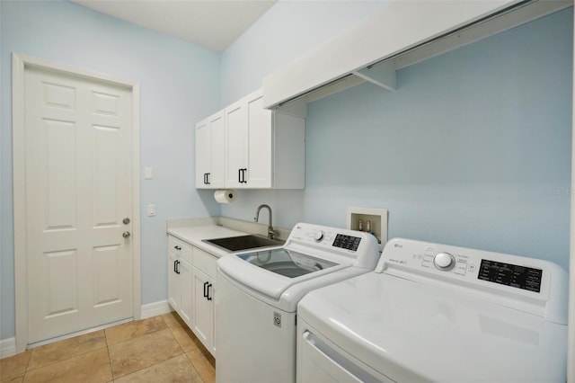 laundry area with washer and clothes dryer, cabinets, and sink