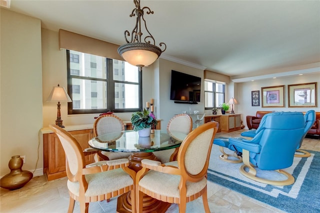 dining space with ornamental molding