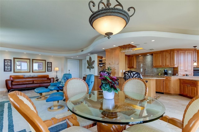 dining room with sink and a chandelier