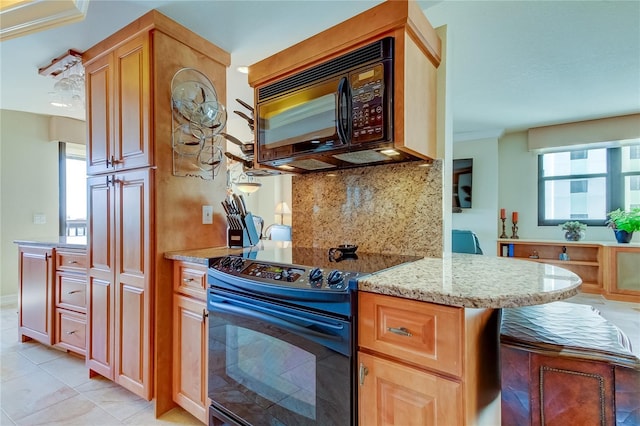 kitchen featuring light stone counters, backsplash, kitchen peninsula, light tile patterned flooring, and black appliances