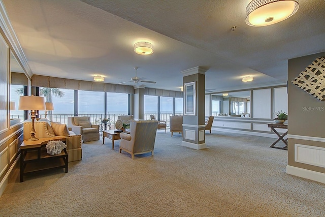 living room with ceiling fan, carpet floors, a textured ceiling, and a wealth of natural light