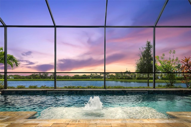 pool at dusk with glass enclosure and a water view