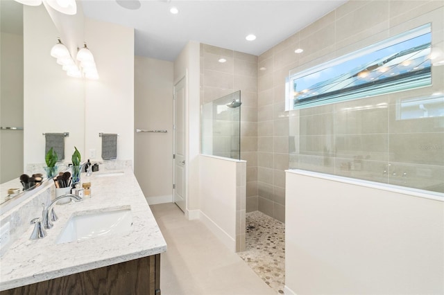 bathroom featuring vanity and a tile shower