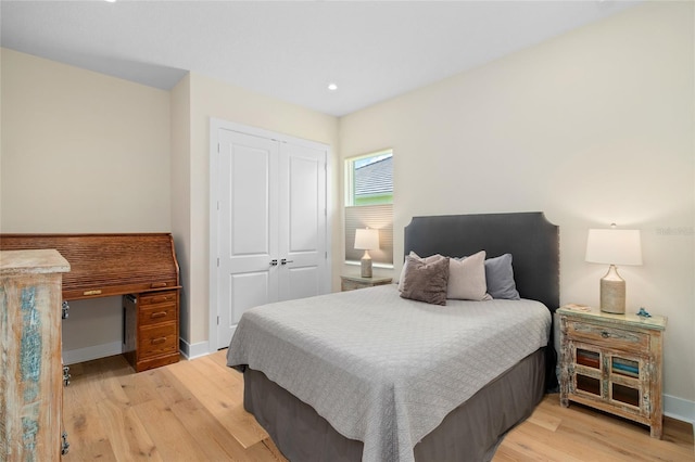 bedroom featuring light hardwood / wood-style floors and a closet