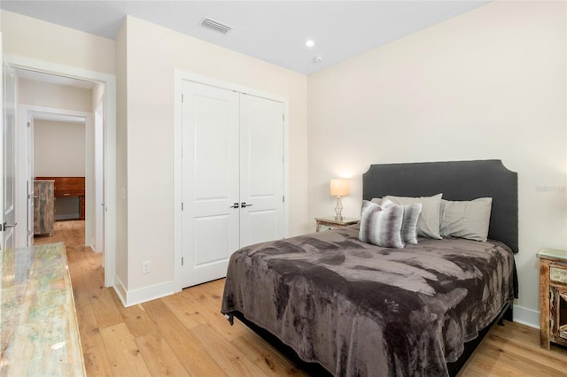 bedroom featuring light hardwood / wood-style floors and a closet