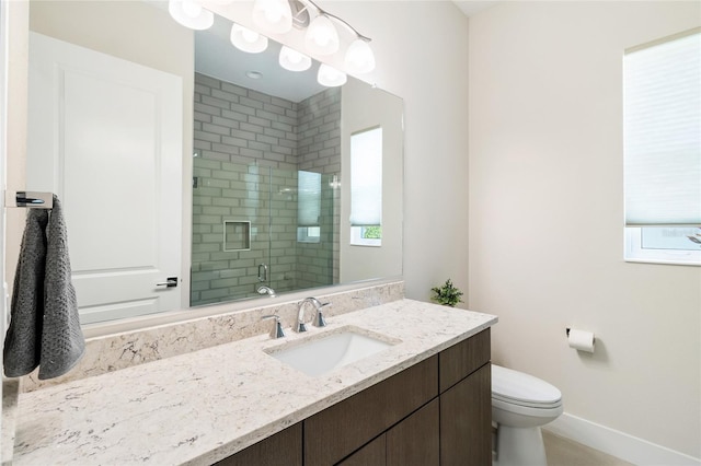 bathroom with walk in shower, vanity, and toilet