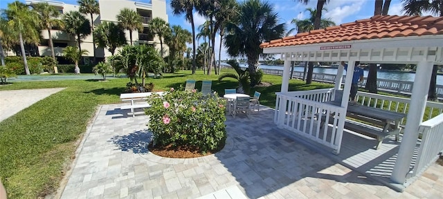 view of community featuring a yard and a patio area