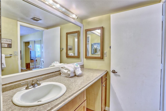 bathroom with vanity and a textured ceiling