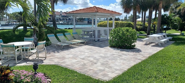 view of community featuring a patio, a gazebo, and a lawn