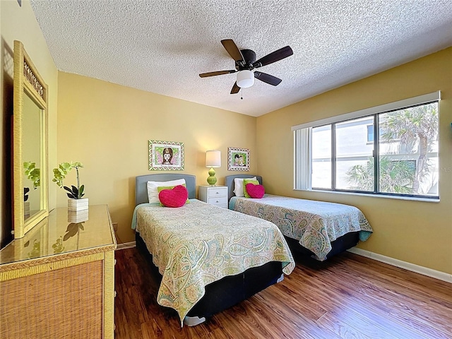 7532 Bayshore Dr Unit 205, Treasure Island, FL 33706 - bedroom with a textured ceiling, wood finished floors, baseboards, and a ceiling fan