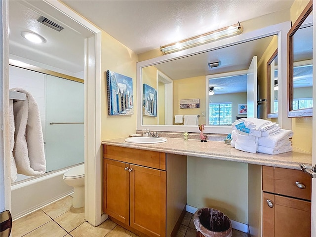 7532 Bayshore Dr Unit 205, Treasure Island, FL 33706 - full bath with vanity, toilet, tile patterned flooring, a ceiling fan, and shower / bath combination with glass door