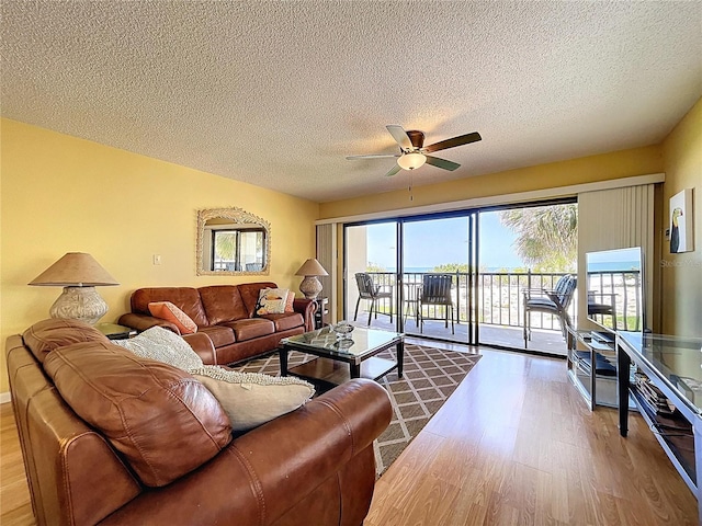 7532 Bayshore Dr Unit 205, Treasure Island, FL 33706 - living room with wood finished floors, ceiling fan, and a textured ceiling