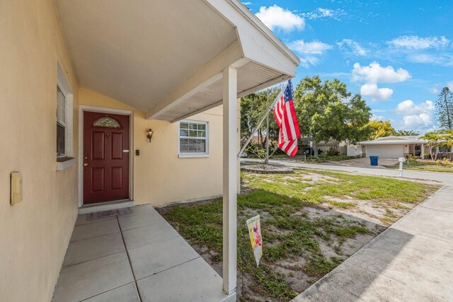 view of exterior entry with a garage