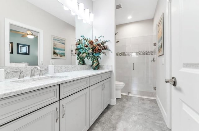 bathroom with vanity, an enclosed shower, ceiling fan, and toilet