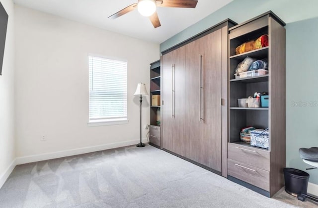 carpeted bedroom featuring a closet and ceiling fan