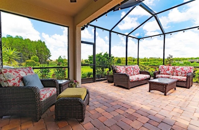 view of patio / terrace with an outdoor living space and glass enclosure