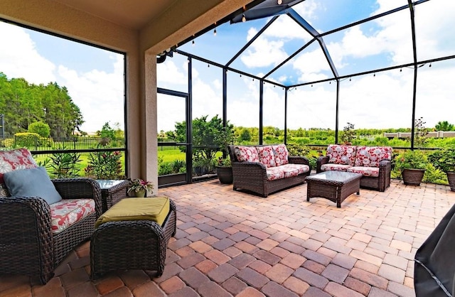 view of patio featuring outdoor lounge area and a lanai