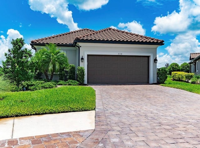 mediterranean / spanish house with a garage