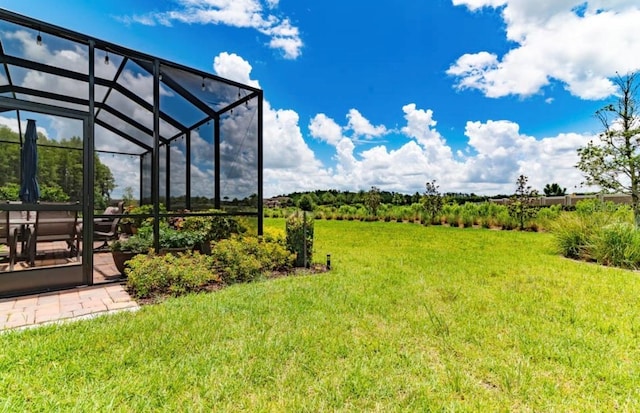 view of yard featuring a rural view and glass enclosure