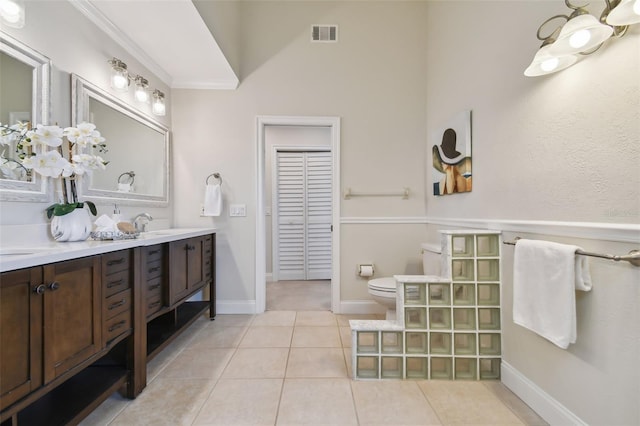 bathroom featuring toilet, vanity, and tile patterned flooring