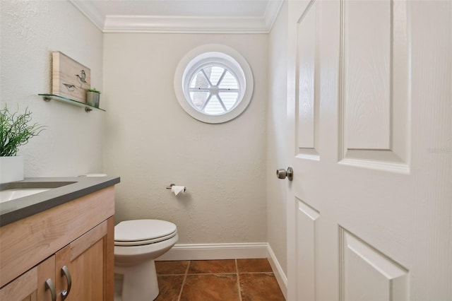 bathroom featuring vanity, toilet, crown molding, and tile patterned floors