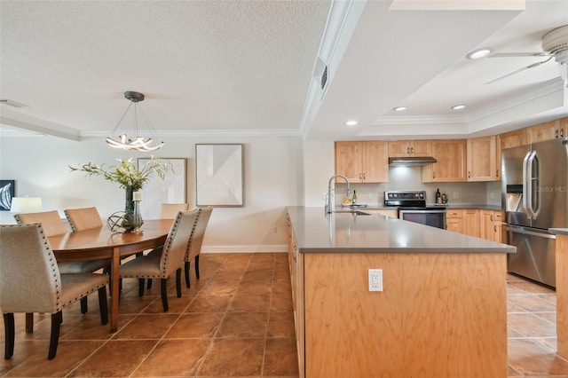 kitchen with crown molding, pendant lighting, appliances with stainless steel finishes, sink, and a center island with sink