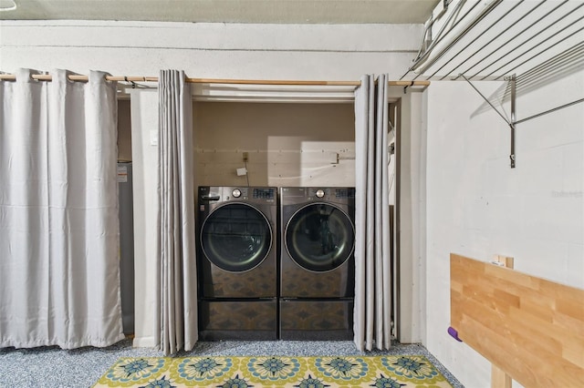 clothes washing area featuring separate washer and dryer