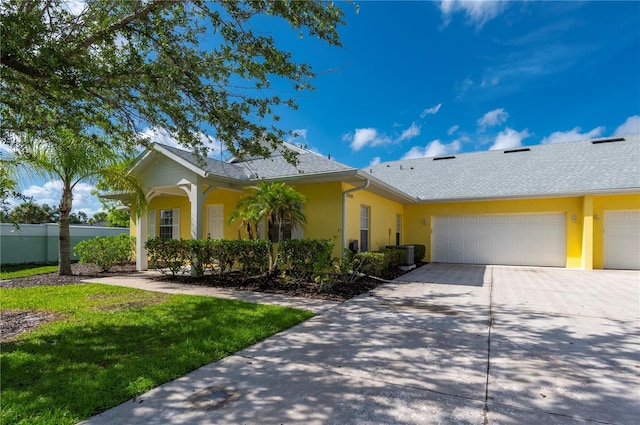 ranch-style house with a front yard and a garage