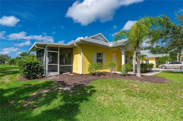 exterior space with a sunroom and a yard