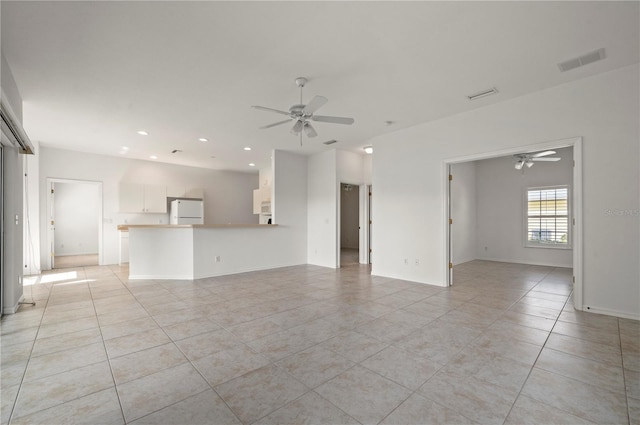 unfurnished living room with ceiling fan and light tile patterned floors