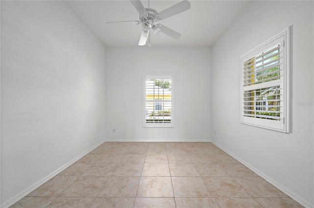 tiled spare room featuring ceiling fan and a wealth of natural light