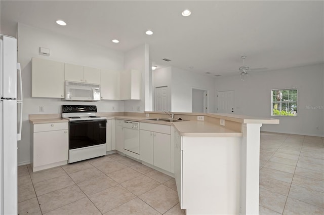 kitchen with white appliances, sink, ceiling fan, light tile patterned floors, and kitchen peninsula