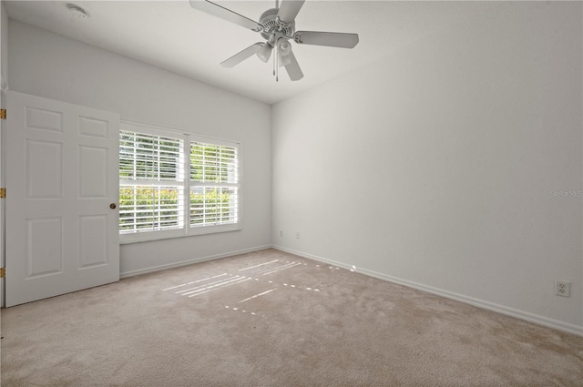 empty room with ceiling fan and light colored carpet