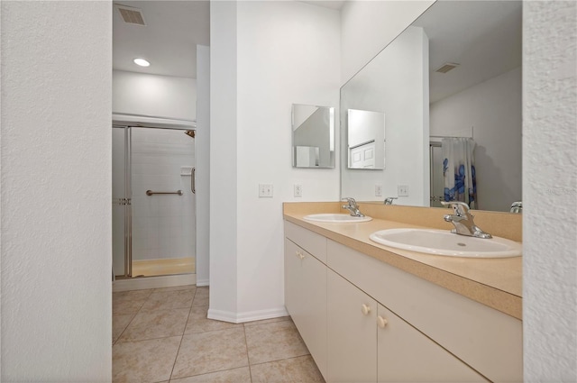 bathroom with tile patterned floors, vanity, and walk in shower