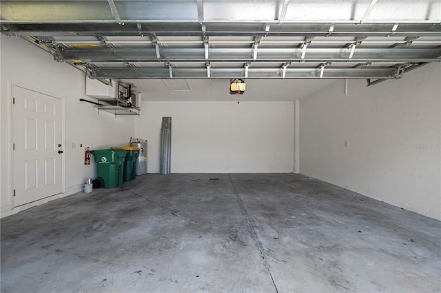 garage with water heater and a garage door opener