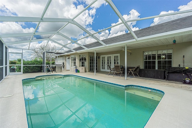 view of swimming pool featuring area for grilling, a lanai, a patio, and french doors