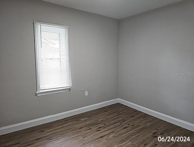 empty room featuring dark hardwood / wood-style floors and a healthy amount of sunlight