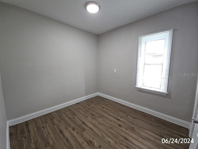 empty room featuring dark hardwood / wood-style flooring