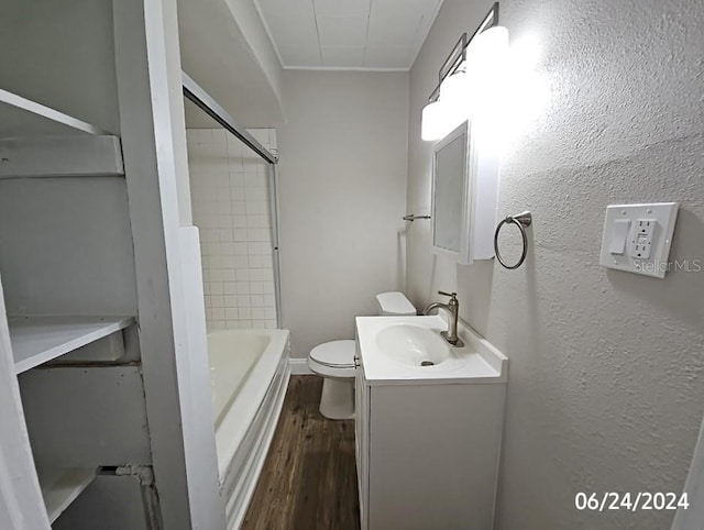 full bathroom featuring hardwood / wood-style floors, vanity, toilet, and tiled shower / bath combo