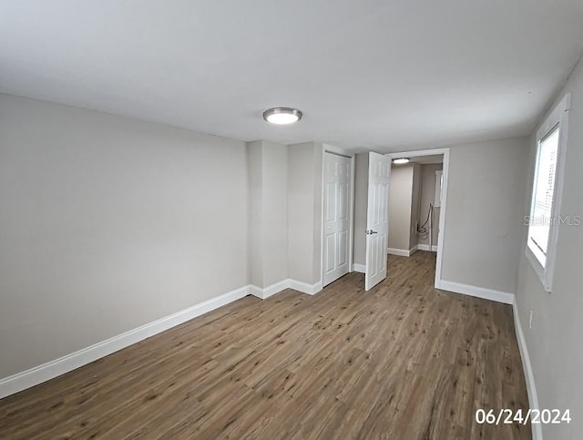 empty room with hardwood / wood-style flooring