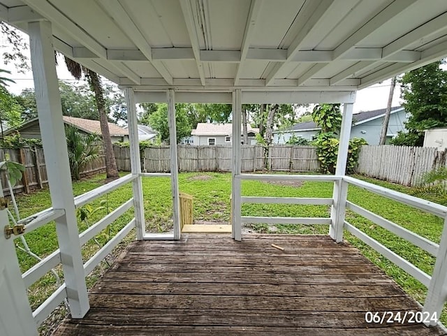 wooden deck with a lawn